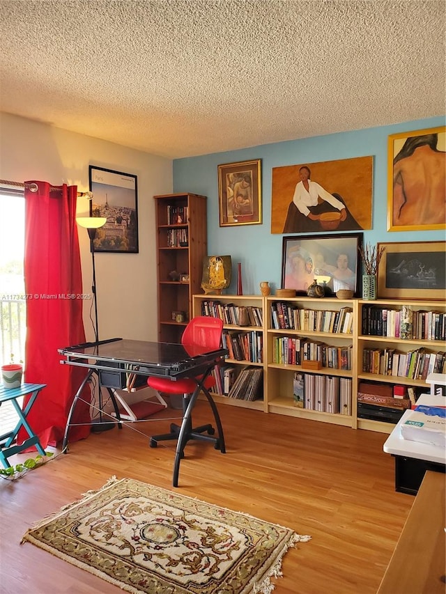 interior space featuring hardwood / wood-style floors and a textured ceiling