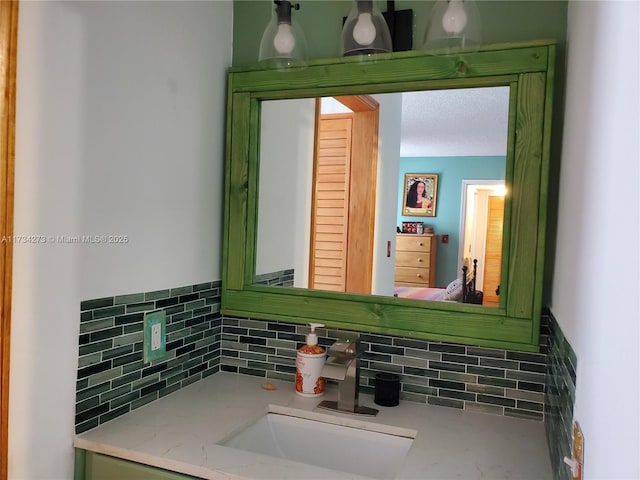 bathroom featuring vanity and backsplash