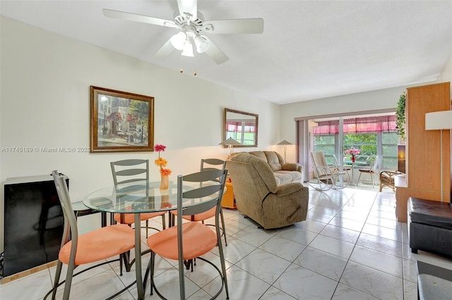 tiled dining room with ceiling fan