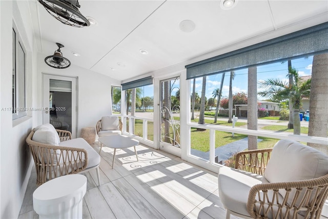 sunroom / solarium featuring vaulted ceiling