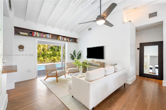 living room featuring ceiling fan, high vaulted ceiling, beam ceiling, and hardwood / wood-style floors