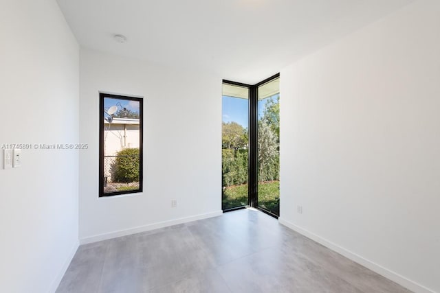 empty room with expansive windows and a healthy amount of sunlight