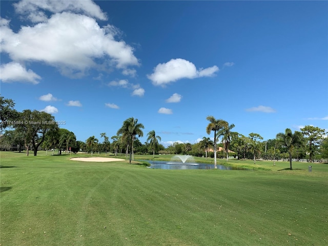 view of home's community featuring a lawn and a water view