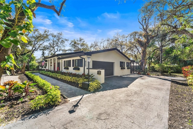 16520 SW 80th Ave, Palmetto Bay, FL 33157 - view of side of property with asphalt driveway, a garage, and stucco siding