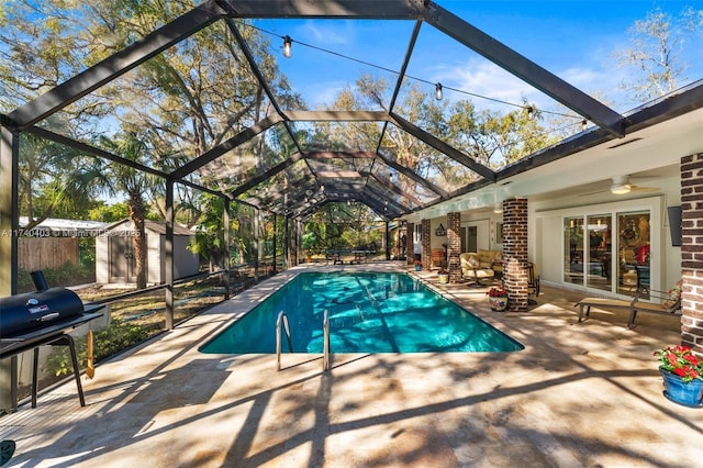 16520 SW 80th Ave, Palmetto Bay, FL 33157 - swimming pool featuring a patio area, area for grilling, a storage unit, ceiling fan, and a lanai