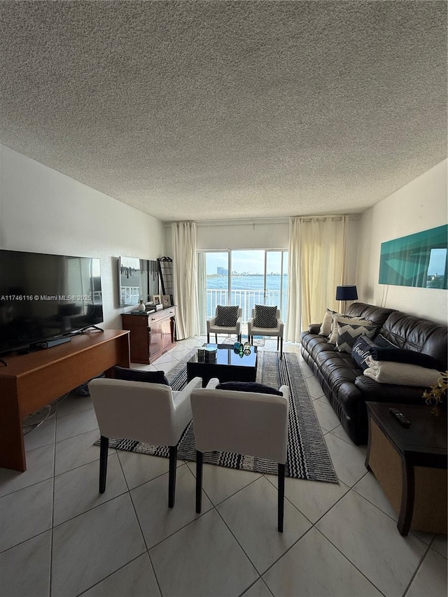 living room featuring a textured ceiling and light tile patterned floors