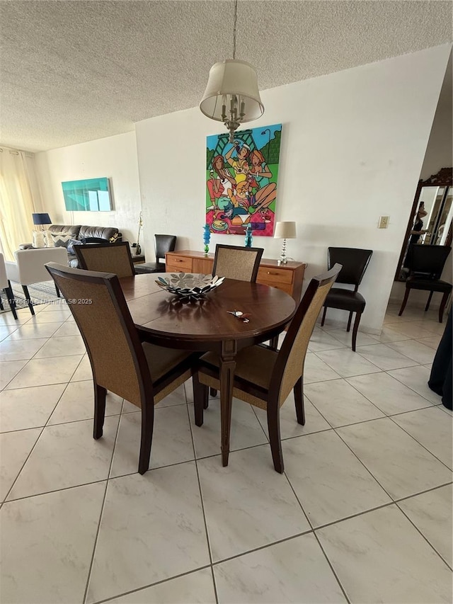 tiled dining room with a textured ceiling