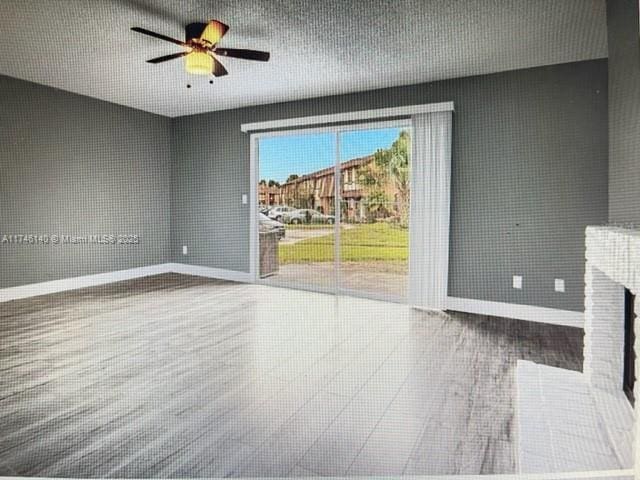 unfurnished living room featuring ceiling fan