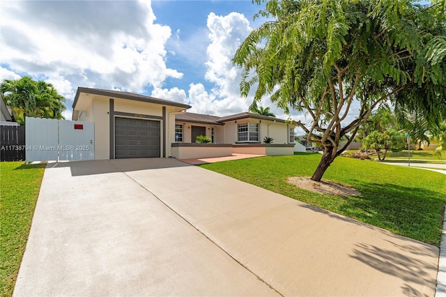 view of front of property with a garage, a front yard, concrete driveway, and stucco siding