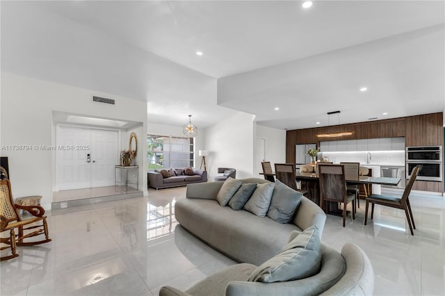 living room featuring visible vents and recessed lighting