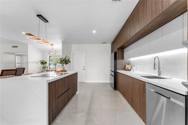 kitchen with pendant lighting, dishwasher, a sink, and modern cabinets