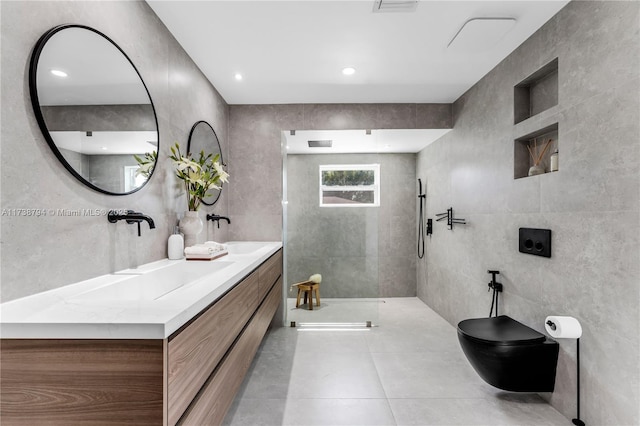 full bath featuring a walk in shower, tile patterned flooring, toilet, vanity, and tile walls