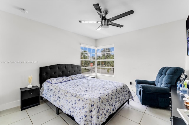 bedroom with a ceiling fan, baseboards, and light tile patterned floors