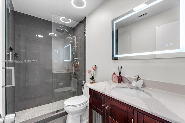 full bathroom featuring visible vents, vanity, toilet, and walk in shower