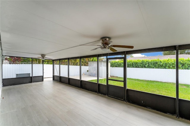 unfurnished sunroom featuring a ceiling fan