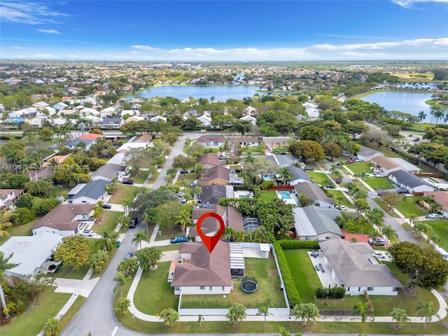 bird's eye view with a water view and a residential view