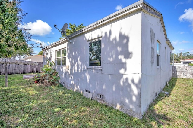 view of property exterior with a lawn