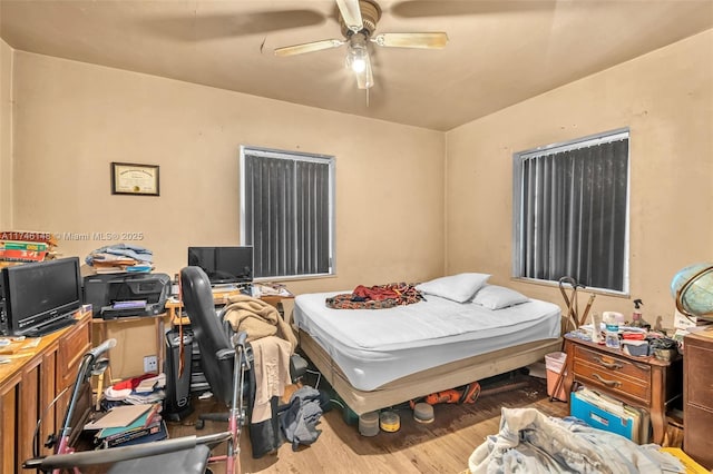 bedroom featuring hardwood / wood-style floors and ceiling fan