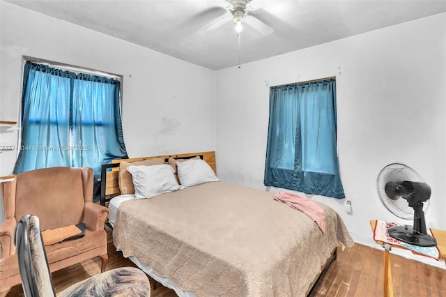 bedroom with ceiling fan and hardwood / wood-style floors