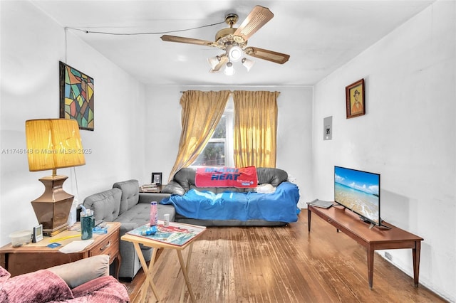 living room featuring ceiling fan and hardwood / wood-style floors