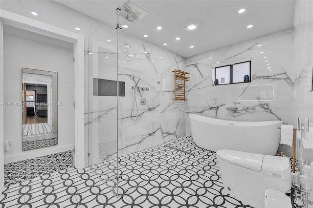 full bath with toilet, a marble finish shower, a freestanding bath, and recessed lighting