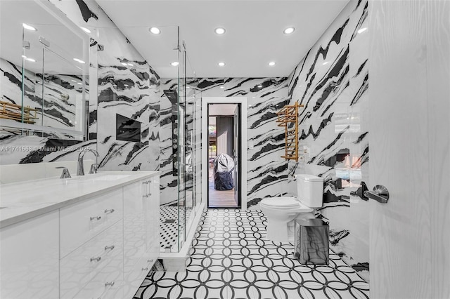 bathroom featuring vanity, a marble finish shower, toilet, and recessed lighting