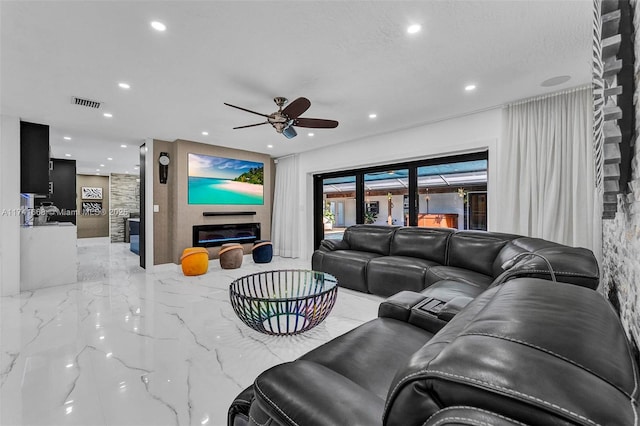 living area with marble finish floor, visible vents, a ceiling fan, and recessed lighting