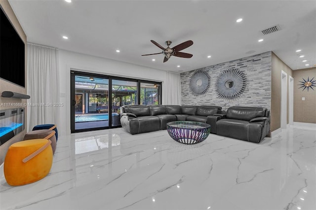 living room with stone wall, recessed lighting, a ceiling fan, visible vents, and marble finish floor