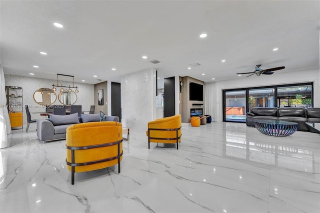 interior space featuring stone wall, marble finish floor, and recessed lighting