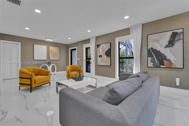 living area with marble finish floor, visible vents, and recessed lighting