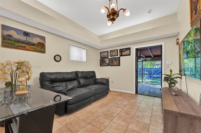 living area featuring light tile patterned floors, baseboards, and an inviting chandelier