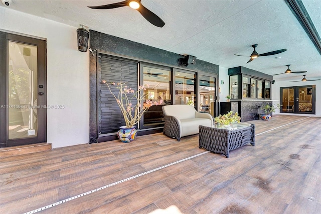 view of patio / terrace with french doors and a ceiling fan