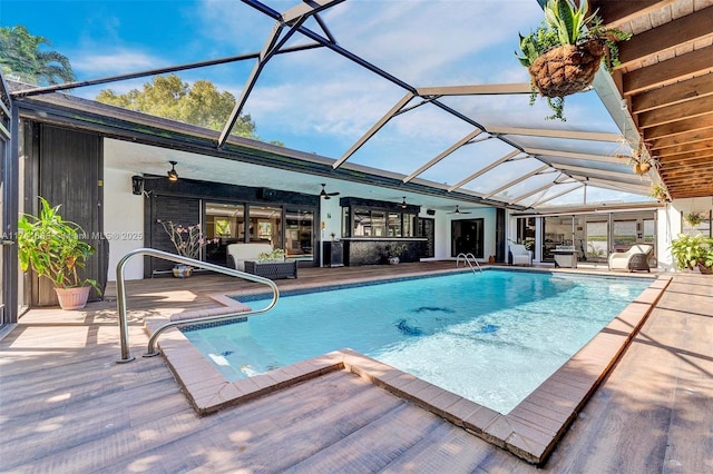 outdoor pool featuring a lanai, ceiling fan, and a patio