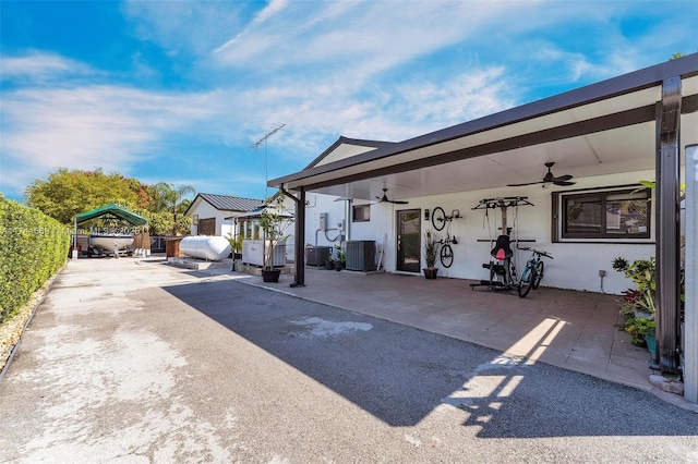 view of patio / terrace with ceiling fan, fence, and central air condition unit