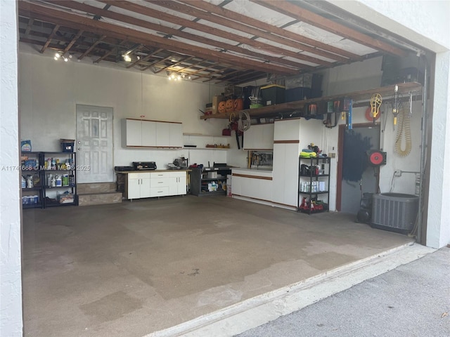 garage featuring central AC and a workshop area