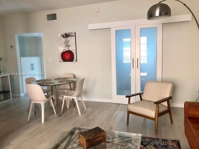 dining room featuring hardwood / wood-style flooring and french doors