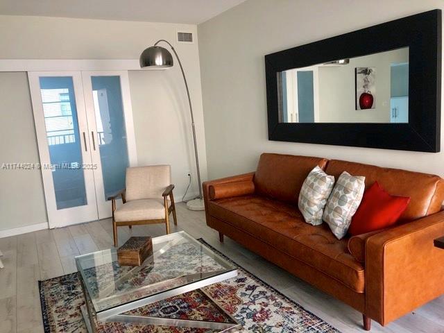 living room featuring hardwood / wood-style floors and french doors