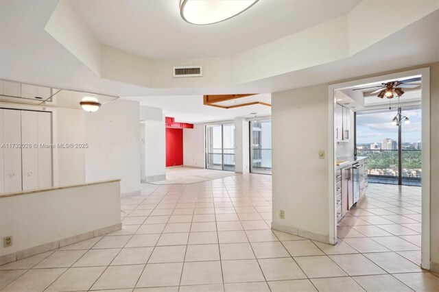 hall featuring plenty of natural light and light tile patterned floors