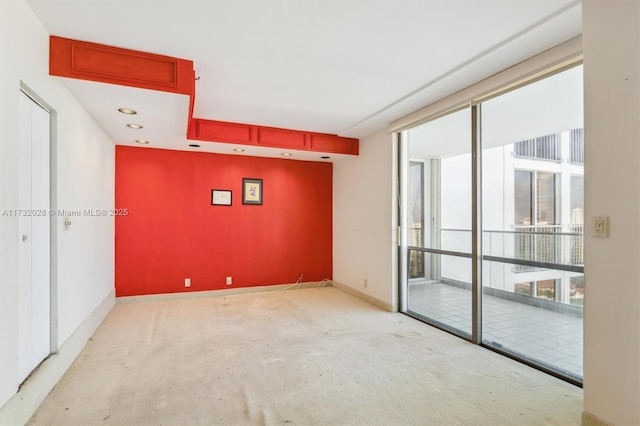 carpeted empty room with expansive windows