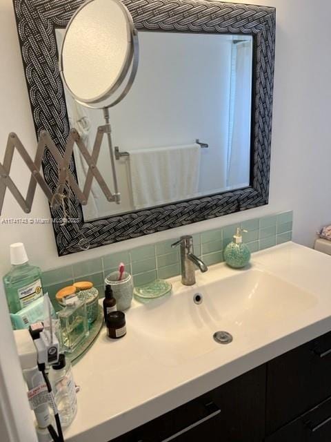 bathroom featuring vanity and backsplash