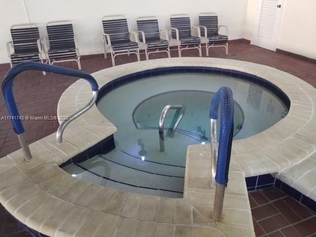 view of pool featuring a hot tub