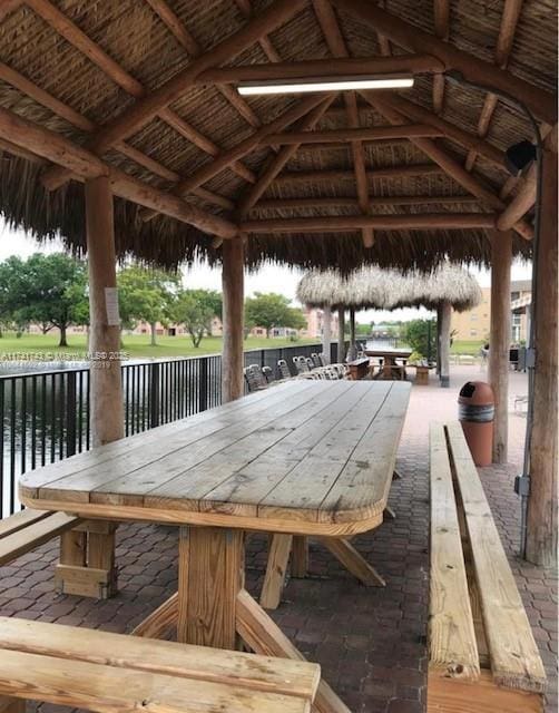 view of community with exterior bar, a gazebo, and a water view