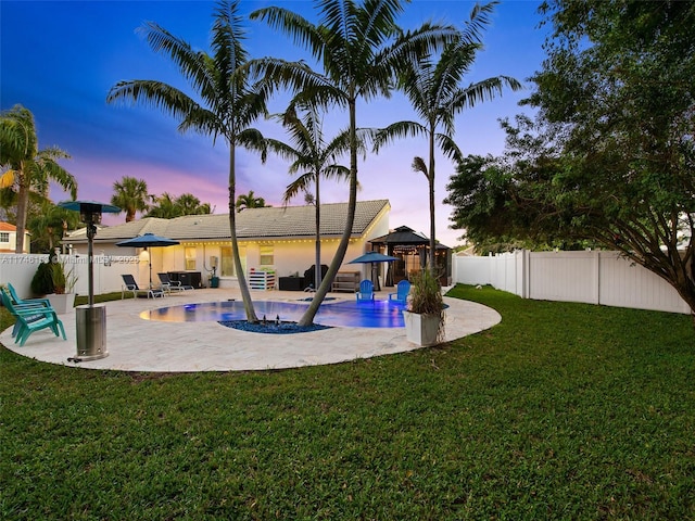 exterior space with a patio area and a lawn