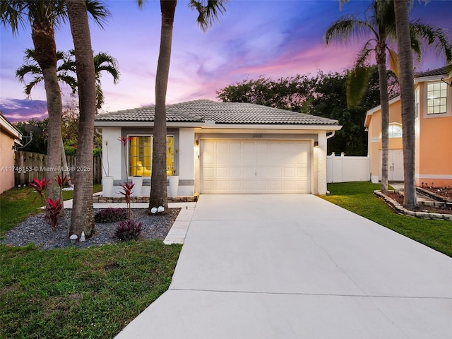 view of front of home featuring a garage and a yard