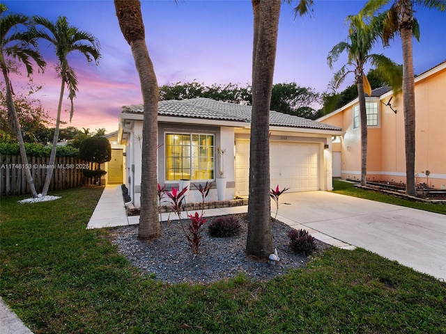 view of front of property featuring a yard and a garage