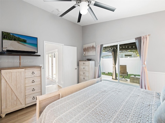 bedroom with access to outside, light hardwood / wood-style floors, and ceiling fan