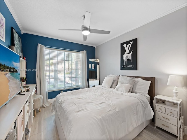 bedroom with crown molding, ceiling fan, and light hardwood / wood-style flooring