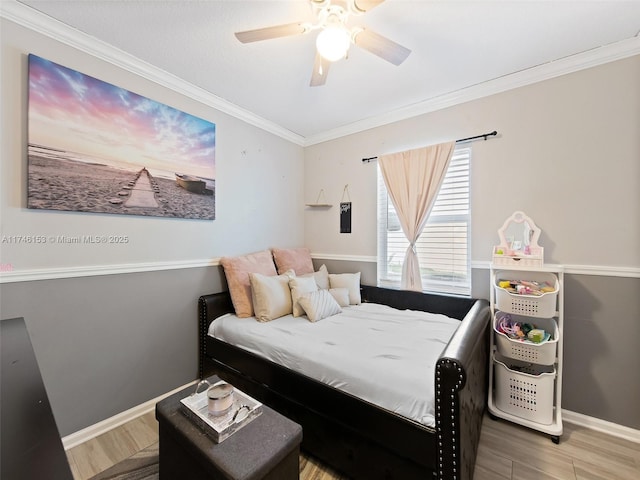 bedroom with hardwood / wood-style floors, ornamental molding, and ceiling fan