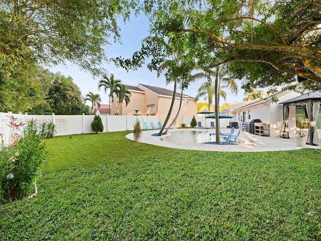 view of yard featuring a fenced in pool, a gazebo, and a patio