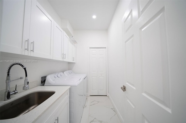 washroom with cabinets, sink, and washer and clothes dryer